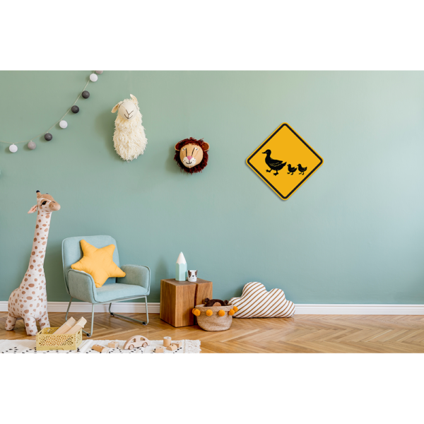 Duck crossing warning sign on a blue wall in a child's bedroom.