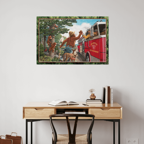 A print of Smokey Bear high fiving a fireman on a wall above a desk.