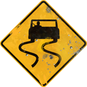 Street Sign with Slippery When Wet symbol. Vintage looking sign with digitally printed bullet holes.