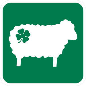 A green sign with a Shamrock Sheep icon with a shamrock on its rear. -St. Patrick’s Day Sign Collection